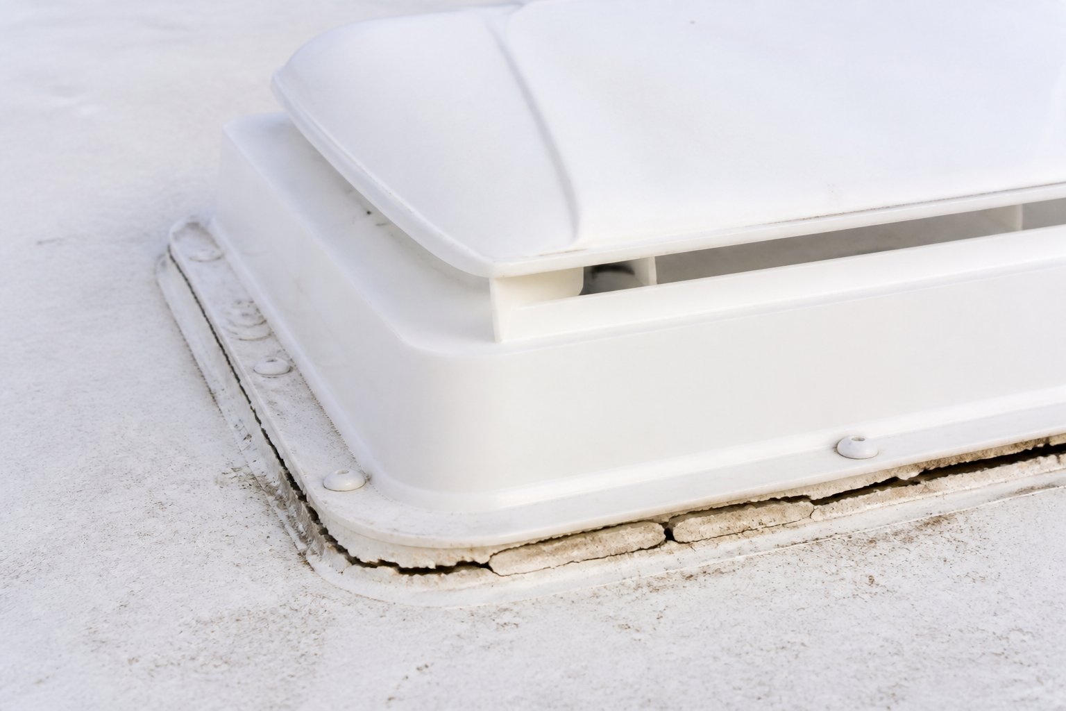 Cracked sealant around an RV roof vent found during a post-monsoon inspection